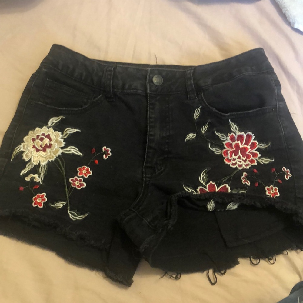 Black shorts with flower embroidery.
